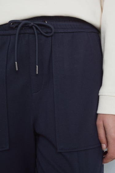 Dona - Pantalons de tela - mid waist - tapered fit - blau fosc
