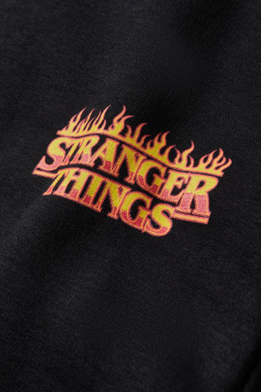 Hommes - CLOCKHOUSE - pantalon de jogging - Stranger Things - noir