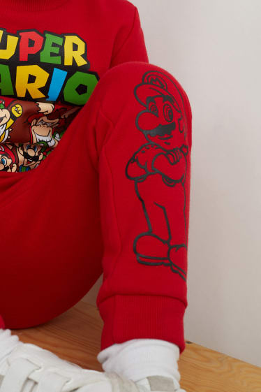 Děti - chlapci - Super Mario - teplákové kalhoty - červená