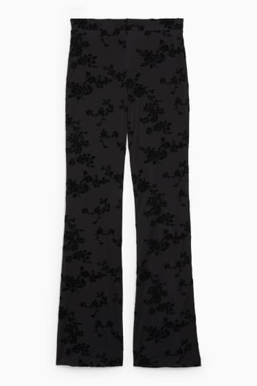 Dámské - CLOCKHOUSE - žerzejové kalhoty - flared - s květinovým vzorem - černá