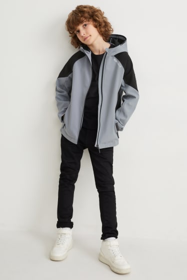 Niños - Chaqueta softshell con capucha - gris / negro