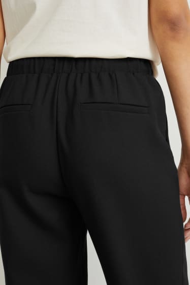 Kobiety - Spodnie materiałowe - średni stan - szerokie nogawki - czarny