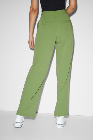 Kobiety - CLOCKHOUSE - spodnie materiałowe - wysoki stan - szerokie nogawki - jasnozielony