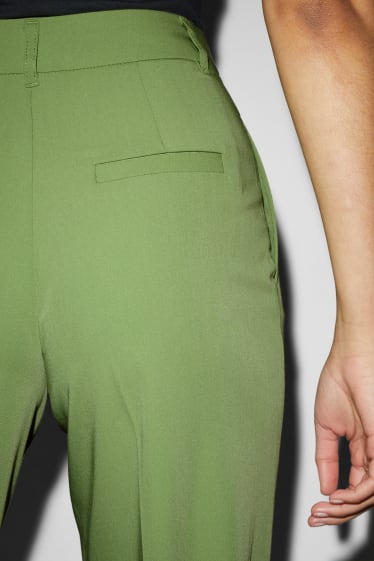 Kobiety - CLOCKHOUSE - spodnie materiałowe - wysoki stan - szerokie nogawki - jasnozielony