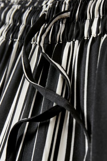 Dona - Pantalons de tela - high waist - tapered fit - negre/blanc