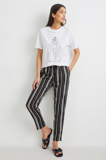 Dona - Pantalons de tela - high waist - tapered fit - negre/blanc