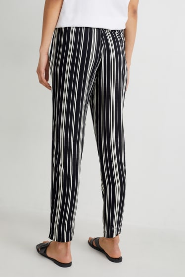 Dona - Pantalons de tela - high waist - tapered fit - negre/blanc