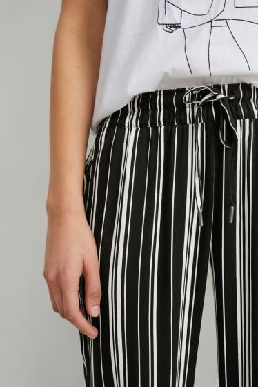 Dona - Pantalons de tela - high waist - tapered fit - negre/blanc