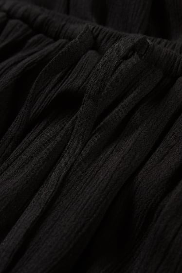 Dona - CLOCKHOUSE - pantalons de tela - mid waist - wide leg - negre