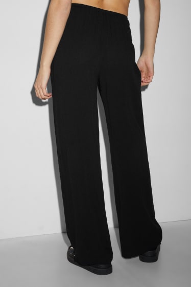 Dona - CLOCKHOUSE - pantalons de tela - mid waist - wide leg - negre
