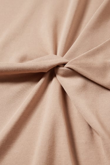 Dames - Kokerjurk met knoop in de stof - beige