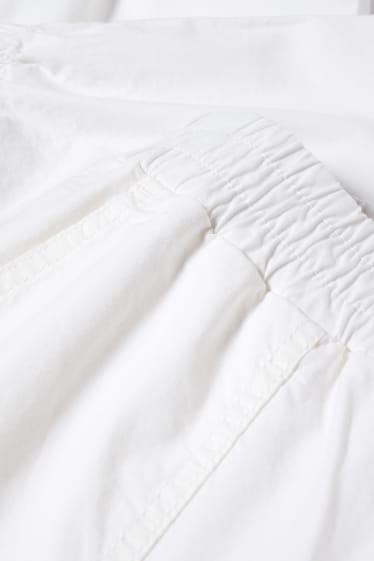 Dona - Pantalons de tela - mid waist - tapered fit - blanc