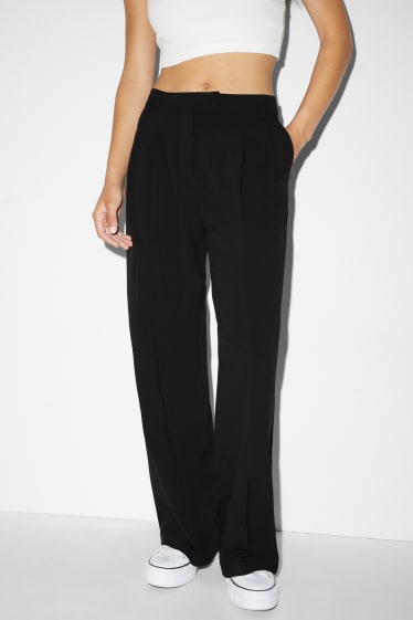 Kobiety - CLOCKHOUSE - spodnie materiałowe - średni stan - szerokie nogawki - czarny
