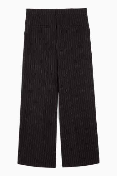 Nastolatki - CLOCKHOUSE - spodnie materiałowe - średni stan - szerokie nogawki - czarny