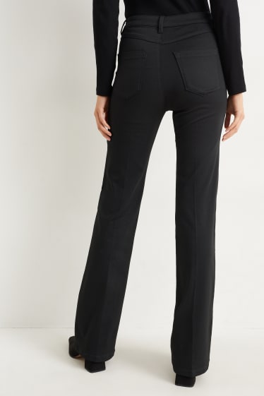 Dona - Pantalons de tela - high waist - flared - negre