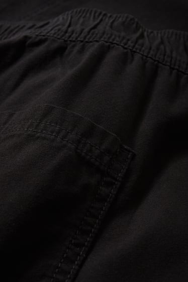 Nastolatki - CLOCKHOUSE - spodnie bojówki - średni stan - relaxed fit - czarny