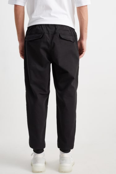 Hommes - Pantalon cargo - jambes fuselées - noir