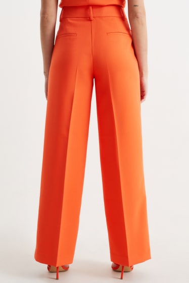 Kobiety - Spodnie materiałowe - wysoki stan - szerokie nogawki - pomarańczowy