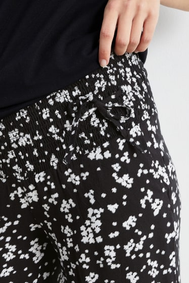 Dámské - Těhotenské kalhoty - palazzo - s květinovým vzorem - černá