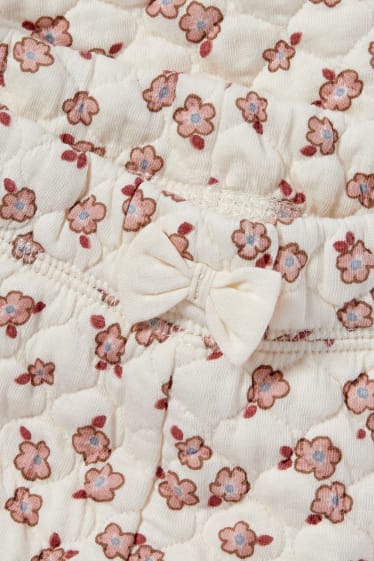 Niemowlęta - Niemowlęce spodnie dresowe - w kwiaty - kremowobiały