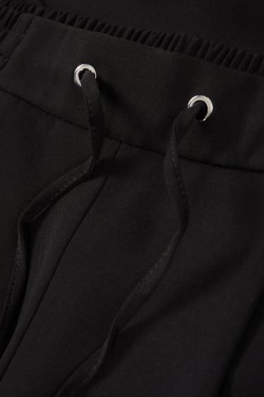Kobiety - Spodnie materiałowe - średni stan - tapered fit - czarny