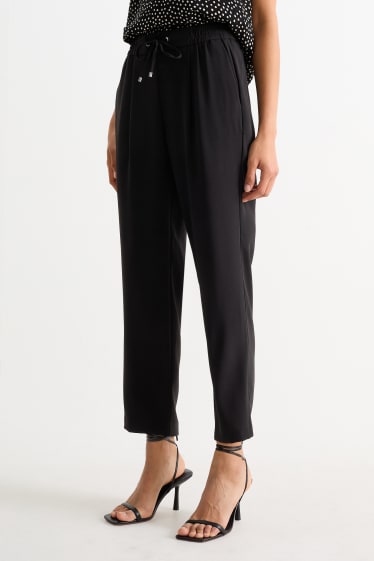 Dona - Pantalons de tela - mid waist - tapered fit - negre