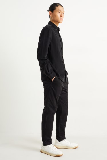 Uomo - Pantaloni chino in velluto - tapered fit - nero