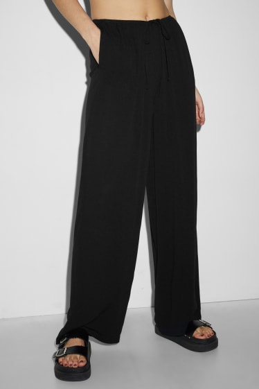 Dona - CLOCKHOUSE - pantalons de tela - mid waist - wide leg - negre