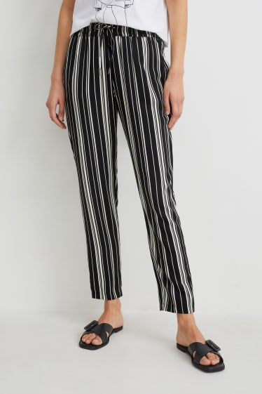 Dona - Pantalons de tela - high waist - tapered fit - negre/blanc