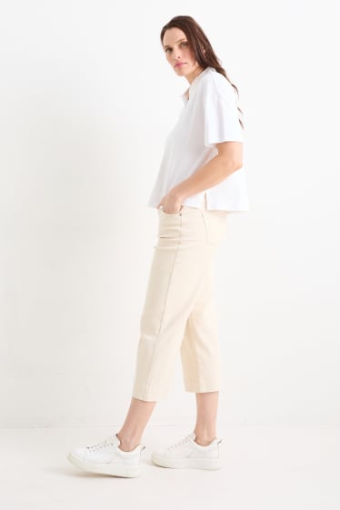 Kobiety - Spodnie materiałowe - średni stan - szerokie nogawki - jasny beż