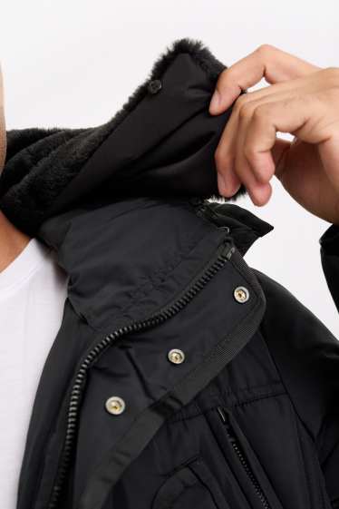 Home - Jaqueta embuatada amb caputxa - impermeable - negre