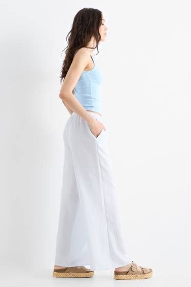 Dona - Pantalons de tela - mid waist - wide leg - blau clar