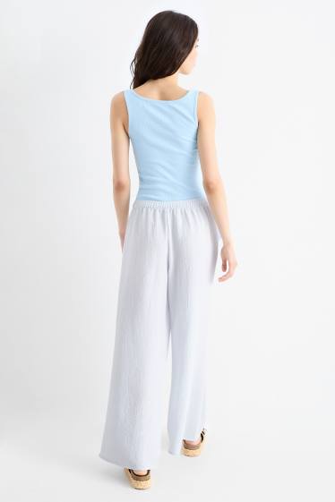 Dona - Pantalons de tela - mid waist - wide leg - blau clar