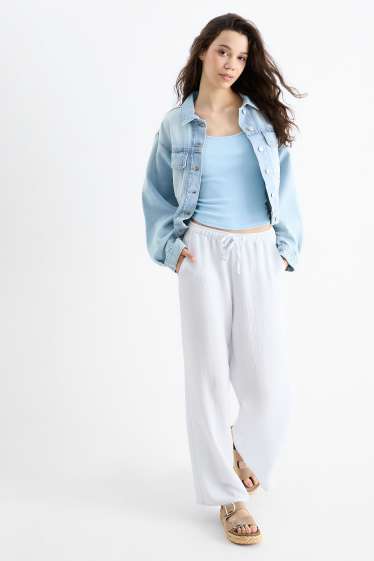 Dona - Pantalons de tela - mid waist - wide leg - blau clar