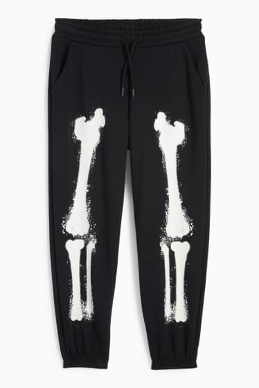 Nen - Esquelet - pantalons de xandall - brilla en la foscor - negre