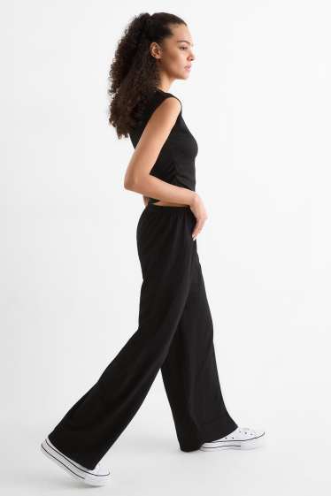 Dámské - Žerzejové kalhoty - mid waist - wide leg - strukturované - černá