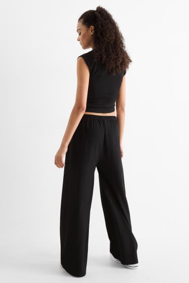 Dámské - Žerzejové kalhoty - mid waist - wide leg - strukturované - černá