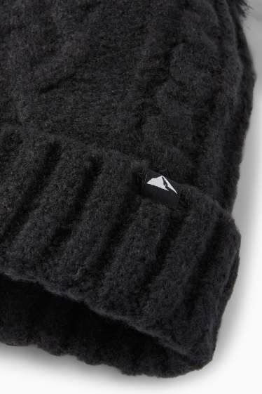 Kinderen: meisjes - Skimuts met pompon - kabelpatroon - zwart