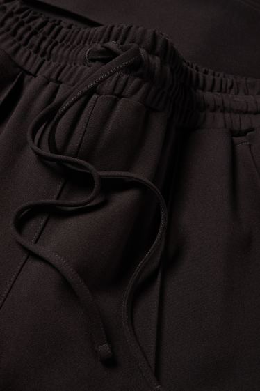 Femei - Pantaloni din jerseu - talie medie - tapered fit - negru