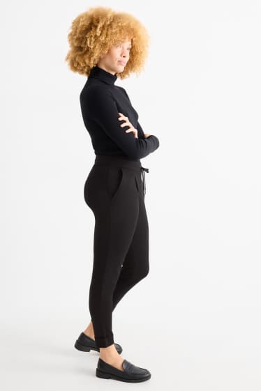 Dámské - Žerzejové kalhoty - mid waist - tapered fit - černá