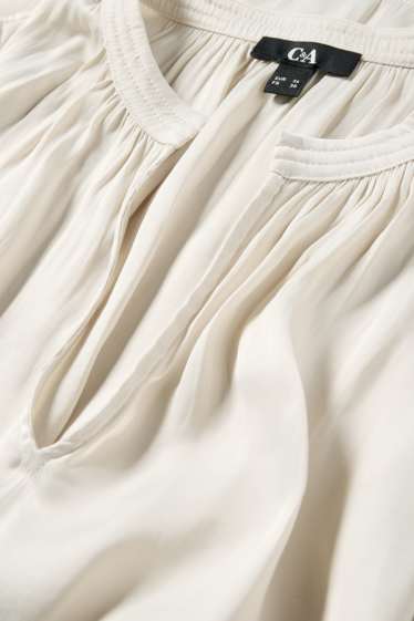 Dona - Brusa amb el coll en punta - blanc trencat