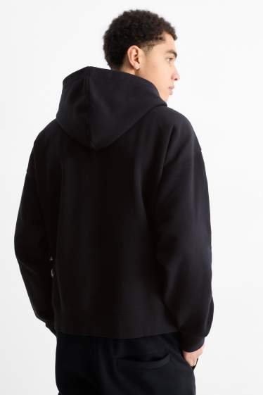 Home - Dessuadora oversized amb caputxa - negre