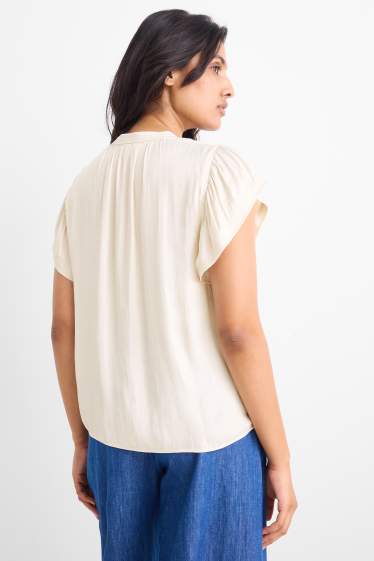 Dona - Brusa amb el coll en punta - blanc trencat