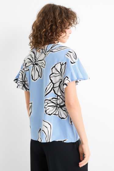 Dona - Brusa amb coll en punta - de flors - blau clar