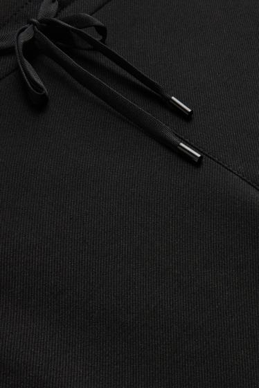 Femmes - Pantalon en toile - mid waist - tapered fit - noir