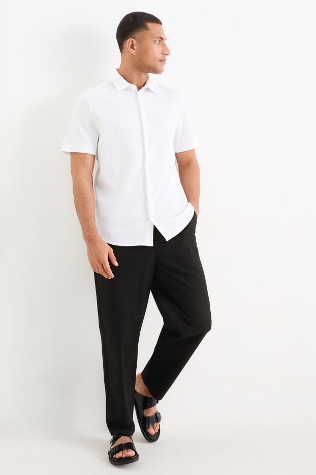Pánské - Kalhoty chino - tapered fit - černá