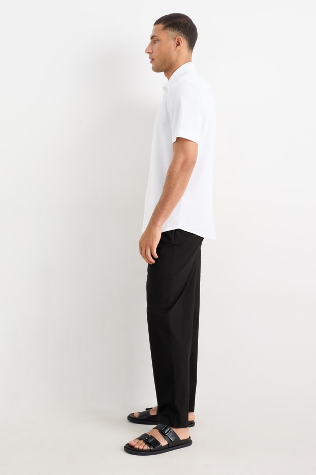 Pánské - Kalhoty chino - tapered fit - černá