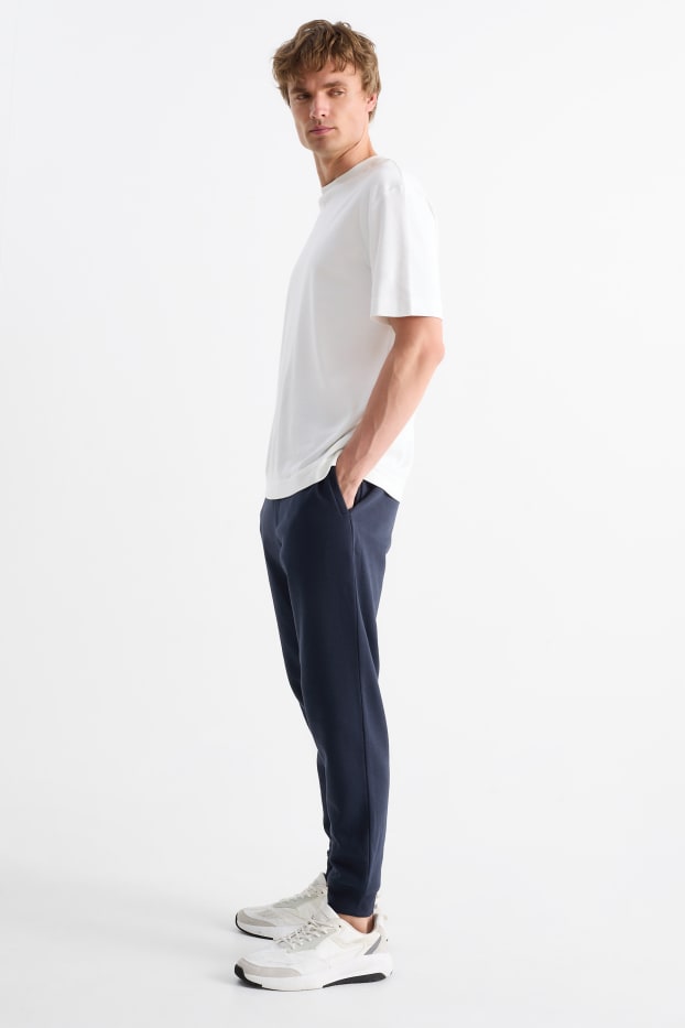 Pánské - Teplákové kalhoty - tmavomodrá