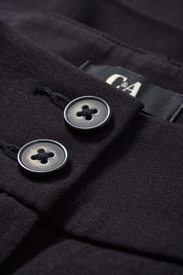 Dona - Pantalons de tela - mid waist - flared fit - negre