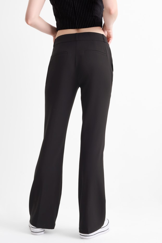 Dona - Pantalons de tela - mid waist - flared fit - negre